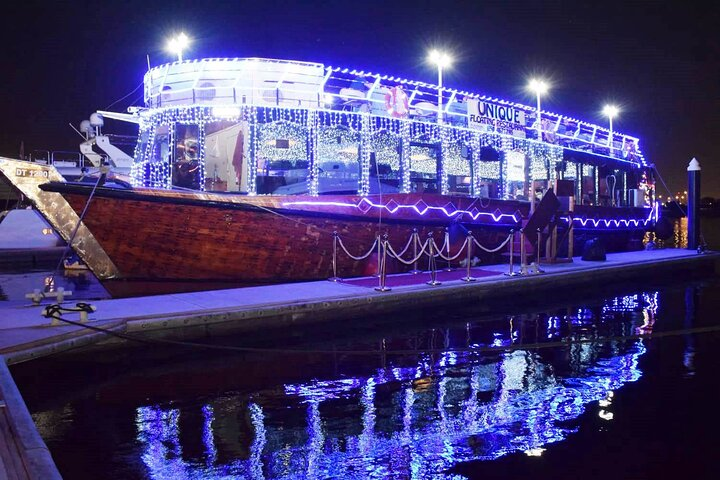 Experience the allure of Dubai Creek with a stunning dhow cruise where twinkling lights reflect on the water as you enjoy a delicious meal among iconic landmarks.